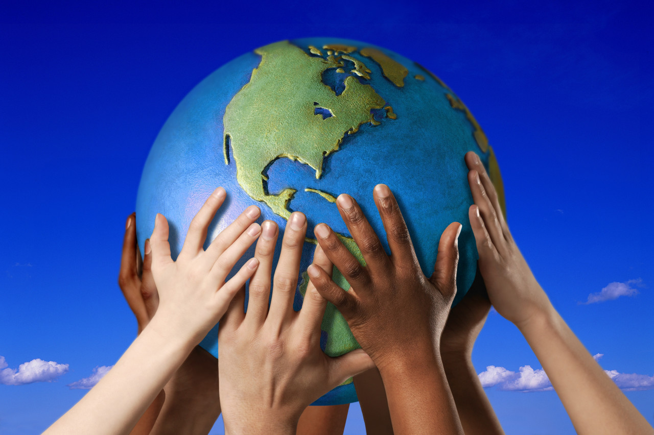 Hands On A Globe Image By © Royalty Free/corbis - Tamarthi